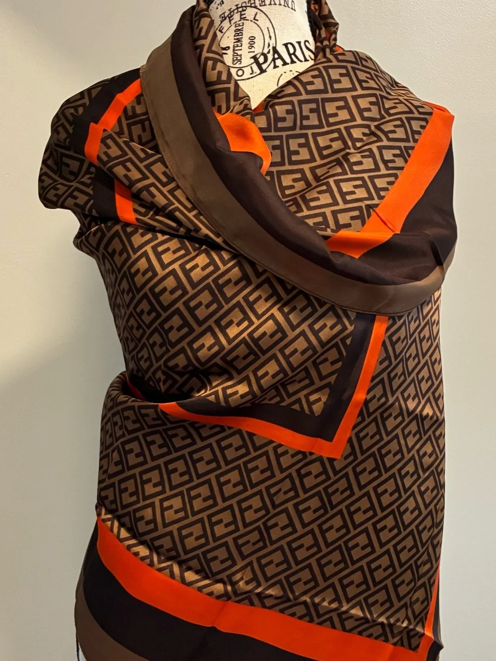NWT brown and orange & tan geometric scarf. Polyester w/Silk feel. Approx 70 in